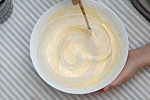 Mixing Baking Dough for Waffles, Egg Yolks and Milk, in a Glass Bowl. Food Preparing Process Photography Concept