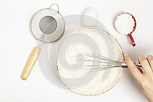 MIxing baking ingredients with dry yeast isolated on white background