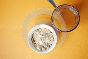 mixing brewers yeast flakes in a glass of water