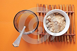 mixing brewers yeast flakes in a glass of water