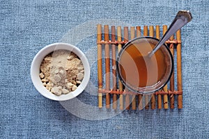 mixing brewers yeast flakes in a glass of water