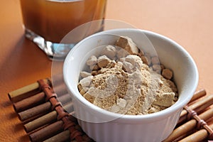 mixing brewers yeast flakes in a glass of water