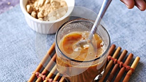 mixing brewers yeast flakes in a glass of water