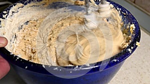 mixing cake mixture in blue bowl