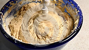 mixing cake mixture in blue bowl