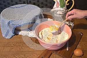 mixing a cake in a traditional bowl