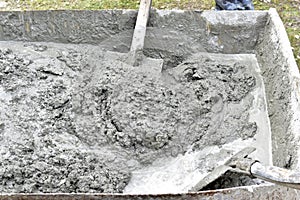 Mixing cement in the muld with shovels for construction