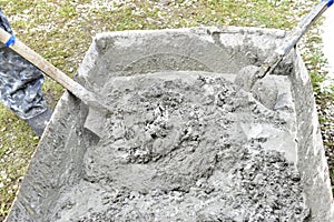 Mixing cement in the muld with shovels for construction