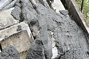 Mixing cement in the muld with shovels for construction