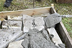 Mixing cement in the muld with shovels for construction