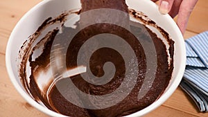 Mixing chocolate cake brownie dough with spatula
