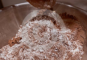 Mixing cocoa and flour in a bowl.