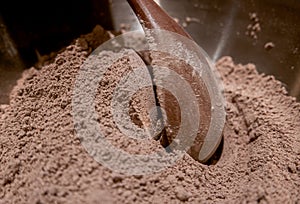 Mixing cocoa and flour in a bowl.