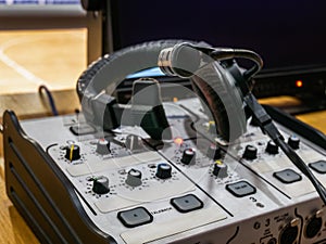 Mixing console and headset at the workplace of a sports commentator photo
