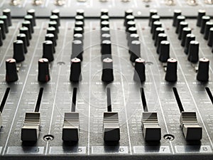 Mixing desk faders and knobs