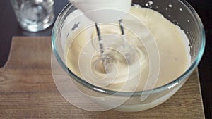 Mixing dough in bowl with motor mixer. Baking ingredients. Baking cake