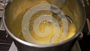 Mixing dough for bread baking with professional kneader spiral machine at the manufacturing. The dough is kneaded for