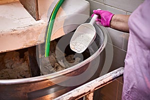 Mixing dough with professional kneader machine at the manufacturing. Equipment for making flour products