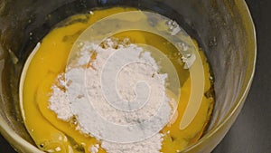 Mixing eggs and icing sugar