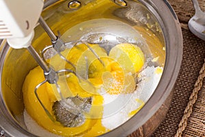 Mixing eggs and sugar for cake.