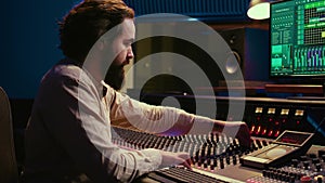 Mixing engineer focuses on blending and balancing individual tunes of a recording