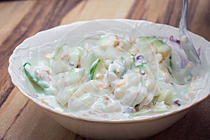 Mixing a fresh and natural yogurt salad