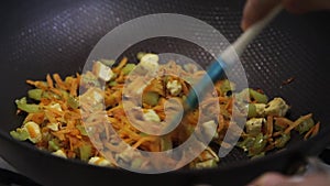 Mixing vegetables in a wok