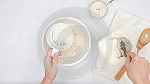 Mixing yeast starter and flour in a bowl. Step by step bread dough recipe