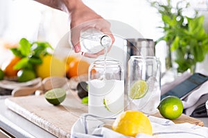 Mixologist making refreshing cocktail with hard seltzer at home