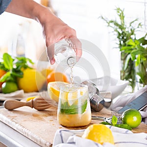 Mixologist making refreshing cocktail with hard seltzer at home