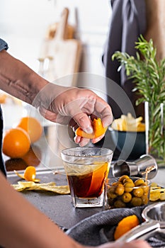 Mixologist making refreshing cocktail with vermouth at home