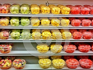 Mixture of colorful fruit choped and served for to go, being sold on shelves of supermarket