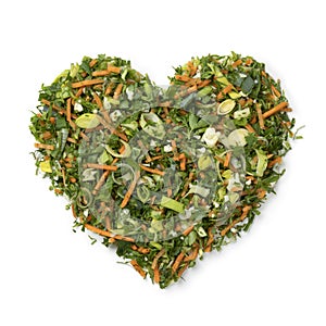 Mixture of fresh chopped variation of vegetables in heart shape on white background