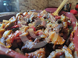 Mixture of fried vegetables and meat ready to go into the oven