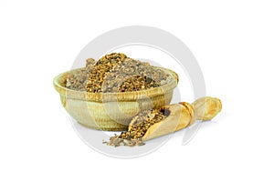 A mixture of ground peppers in a wooden cup with a spoon for spices isolated on a white background. Collection of spices