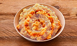 Mixture of pureed carrot and potato in a bowl