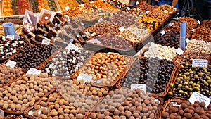 Mixture of Racks with dates dry fruits Raisins and nuts in the market La Boqueria in Barcelona,Spain