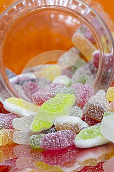Mixture of sugar coated sweets candy in a glass jar.