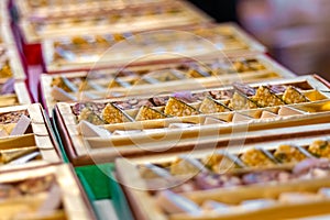 A mixture of various Indian sweets packed in a box. Peda, laddu, mithai, diwali sweets