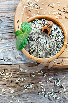 Mixture of white and wild rice in a wooden bowl.