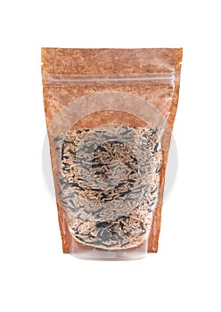 A mixture of wild and brown rice in a brown paper bag. Doy-pack with a plastic window for bulk products. Close-up. White