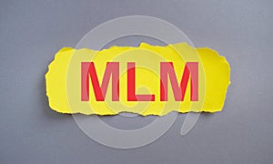 MLM Multi Level Marketing text written on yellow torn paper, Business concept