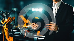 MLP Engineer use advanced robotic software to control industry robot arm in factory
