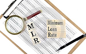 MLR - Minimum Loan Rate text on wooden block on chart background