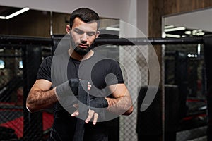 Mma caucasian fighter getting ready for fight, staying on boxing ring, copy space