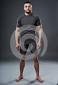 MMA fighter posing on gray