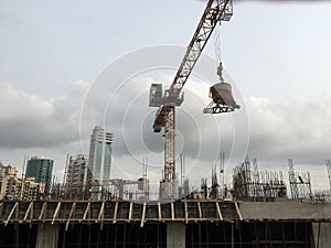 Mmoving liquid concrete into the tower crane bucket at the construction site sanpada Navi Mumbai Maharashtra