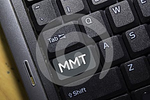 MMT write on keyboard isolated on laptop background photo