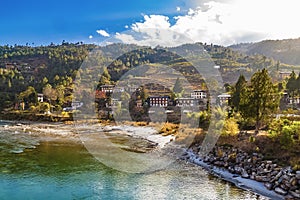 Mo Chhu River on a nice sunny day, Punakha, Bhutan. View from the wooden cantilever bridge near Punakha Dzong to river, houses of