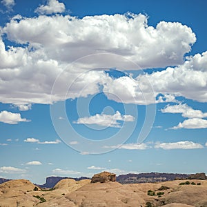 Moab desert landscape under blue sky with clouds